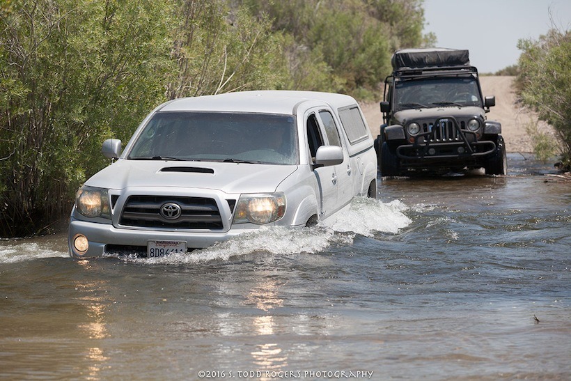 One of our clients in his Toyota Tacoma closely followed by Steve in his jeep JK, crossing a swollen river during a Bodie/Mono adventure. 