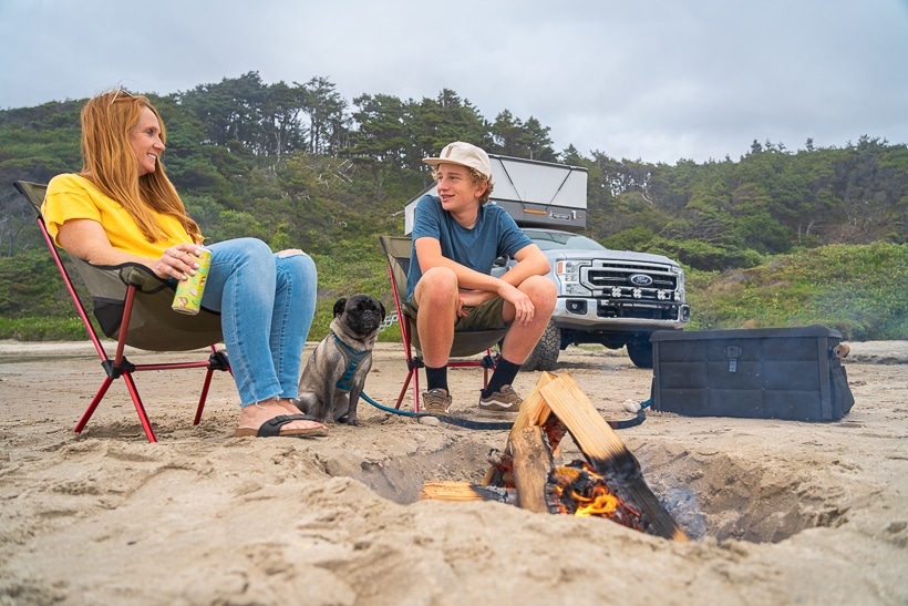 https://theadventureportal.com/wp-content/uploads/2023/08/Overlanders-Enjoying-Campfire-Next-to-Radius-Outfitters-Gearbox.jpg